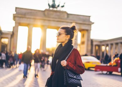 Portrait einer jungen Frau vor dem Brandenburger Tor in Berlin | © Gettyimages.com/Xsandra