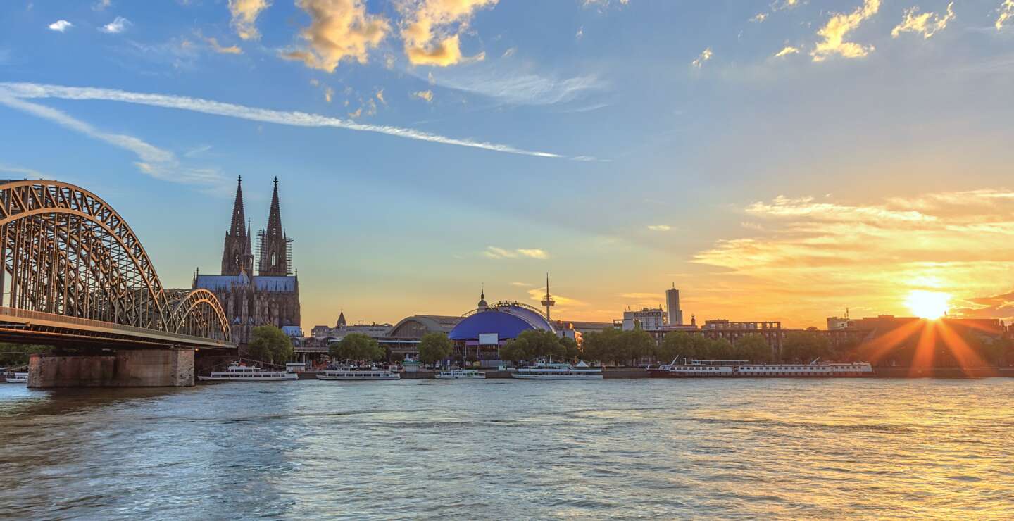 Skyline von Köln mit Kölner Dom und Rhein im Sonnenuntergang | © Gettyimages.com/Noppasin Wongchum
