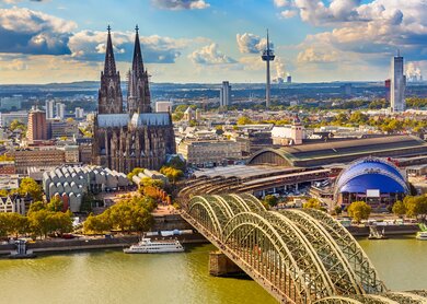 Luftaufnahme ueber dem Rhein mit Blick auf den Dom und die Hohenzollernbruecke in Koeln | © Gettyimages.com/sborisov