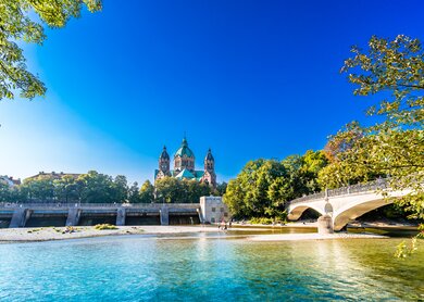 Sommerlandschaft von München, der Fluss Isar und die Lukaskirche im Hintergrund | © Gettyimages.com/StreetFlash