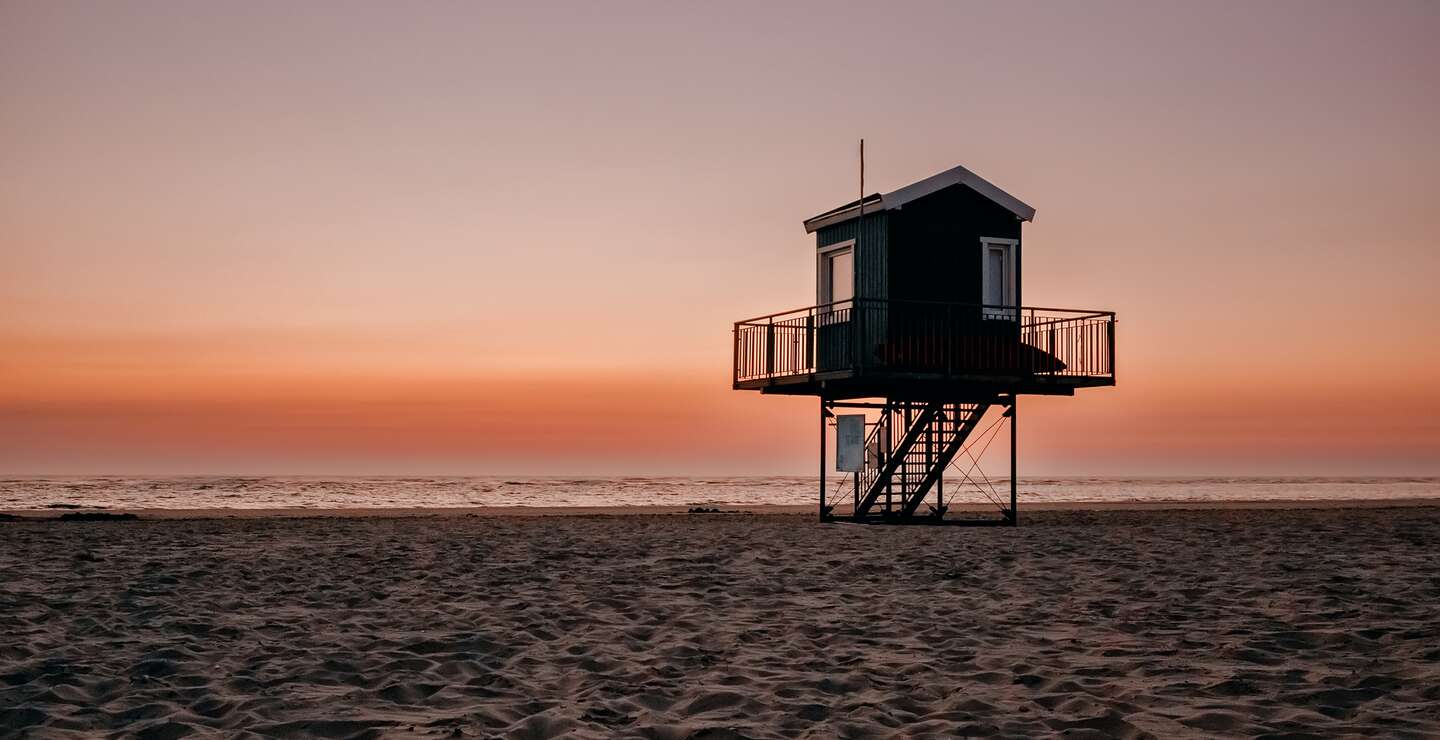 bunter Sonnenuntergang am Strand, Watt, Langeoog, Nordsee | © Gettyimages.com/olgakremer