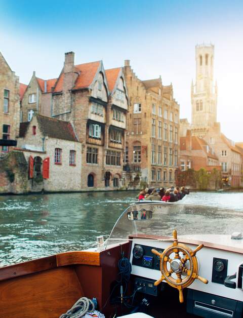 Ein Ausflugsboot fährt auf dem Rozenhoedkai mit Blick auf den Belfried in Bruegge. | © Gettyimages.com/ArtMarie