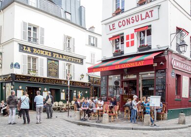 Die Strassen des Viertels Montmartre mit Menschen, die im Cafés Le Consulat sitzen | © Gettyimages.com/olli0815