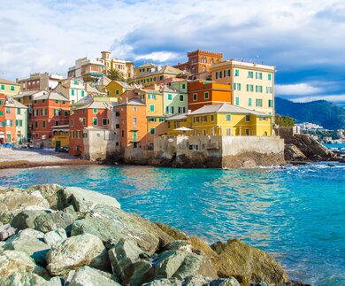 Boccadasse, das malerische Fischerdorf in Genua, Italien, mit einem kleinen Strand umgeben von bunten Häusern entlang der Küste. | © Gettyimmages.com/marcociannarel