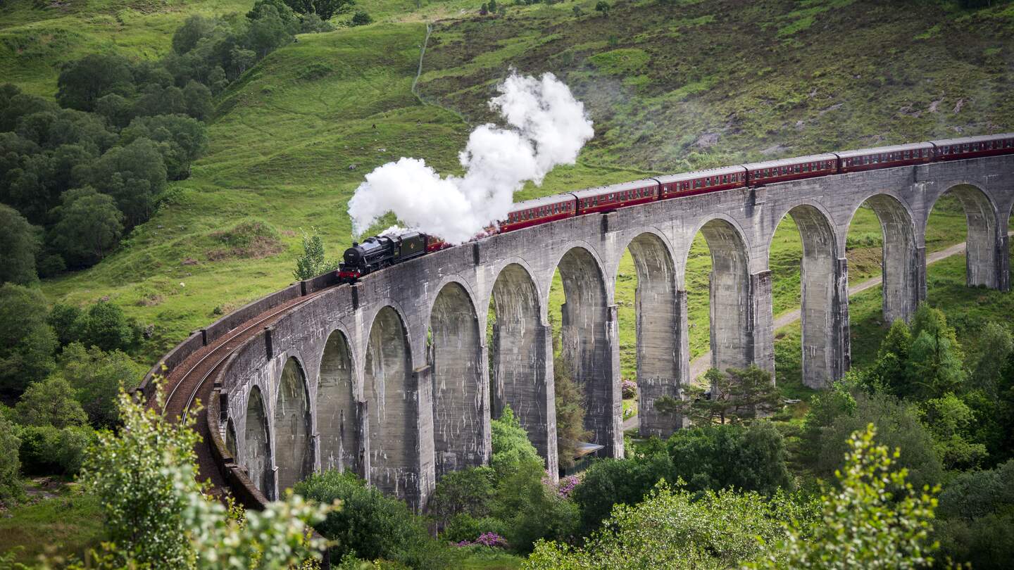 Dampfzug faehrt ueber das Glenfinnan-Viadukt in Schottland | © Gettyimages.com/wanderluster