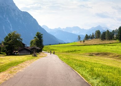 Radsportpaar auf der grünen Wiese unterwegs | © Gettyimages.com/SergeyIT